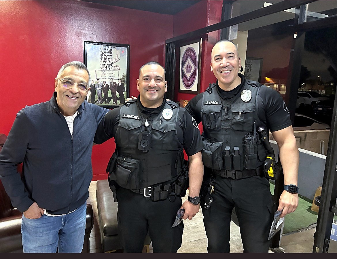 Tony with two officers inside the shop